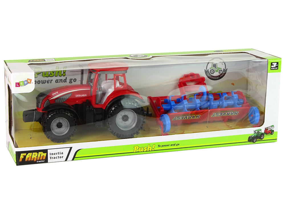Roter Traktor mit Pflug Friktionsantrieb